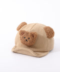 Beige baby hat with bear face and ears on a white background