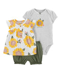 Baby outfit set with floral dress, gray onesie, and green shorts on a white background