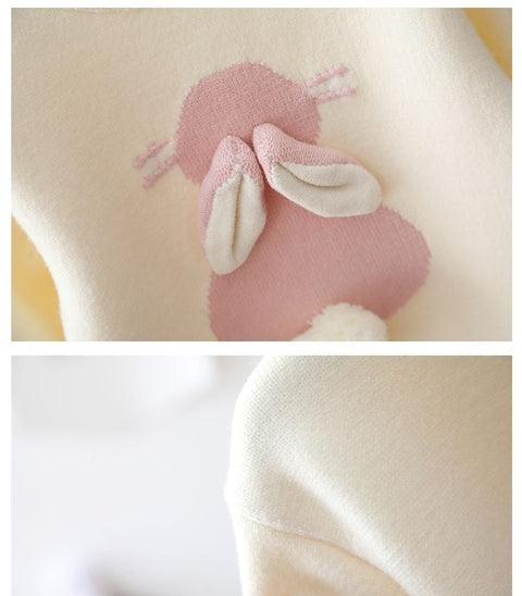 Pink bunny plush toy attached to a white garment with a close-up of the bunny.