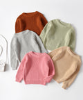 Five colorful sweaters on a white background