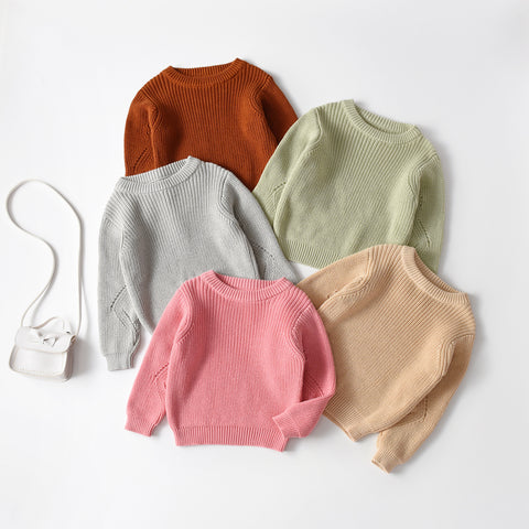 Five colorful sweaters on a white background