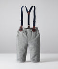 Gray pants with black suspenders on a light gray background