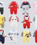 Collection of colorful baby rompers with various designs on a white background
