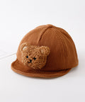 Brown knit cap with teddy bear face on a white background