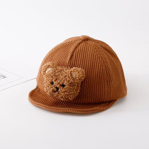 Brown knit cap with teddy bear face on a white background