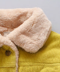 Yellow corduroy jacket with pink fleece collar on a light gray background