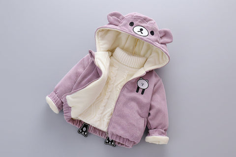 pink jacket with bear design on a gray surface