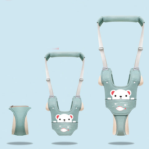 Green baby harness with bear design on a light blue background