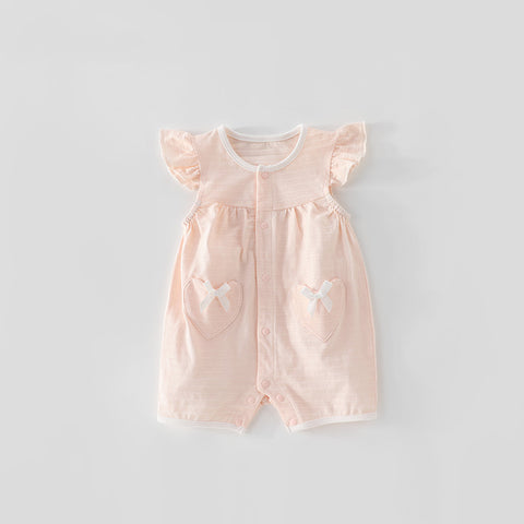 Pink baby romper with heart and bow designs on a light gray background