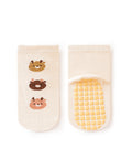 Pair of baby socks with bear designs and textured sole on a white background