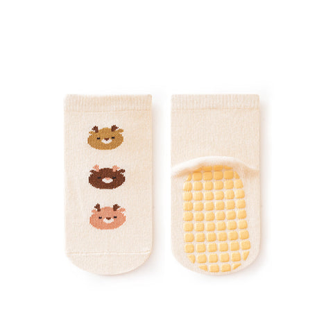 Pair of baby socks with bear designs and textured sole on a white background
