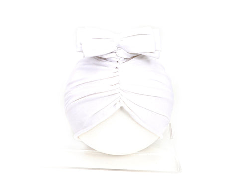 White dress with a bow detail on a white background