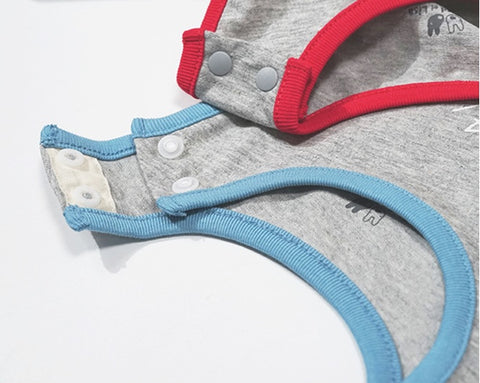 Gray baby romper with red and blue trim on a white background