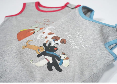 Two children's shirts with cartoon dog designs and text on a white background