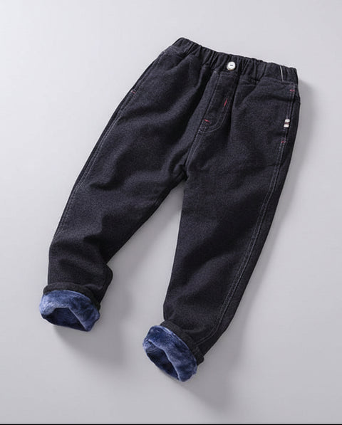 Black pants with blue cuffs on a wooden surface