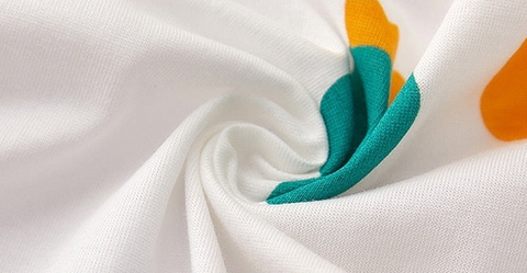 White fabric with green and orange accents on a white background