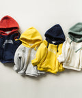 Five colorful hoodies arranged in a row on a light background