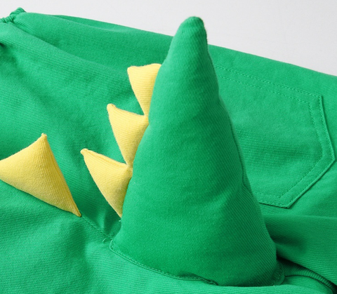 Green dinosaur costume with yellow spikes on a white background