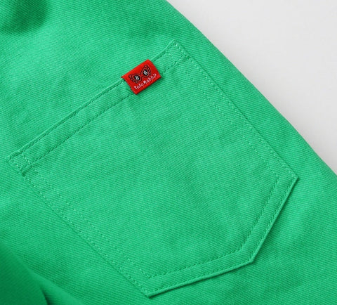 Green shirt pocket with a red label on a white background