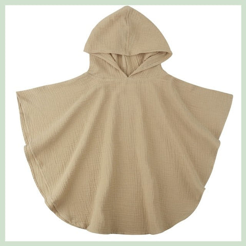 Beige hooded poncho on a light green background