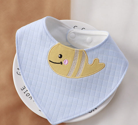 Baby bib with a cartoon fish design on a white plate