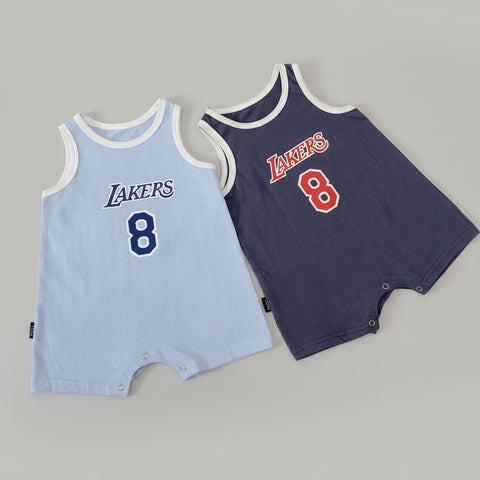 Two baby rompers with Lakers branding on a white surface.