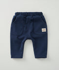 Navy blue baby pants with a visible brand label on a white background