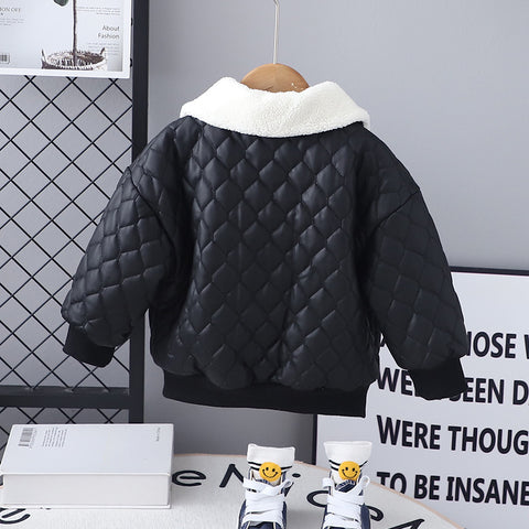 Black quilted jacket with white lining on a hanger against a gray wall.
