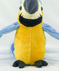 Plush toy parrot with blue wings and yellow body on a white background