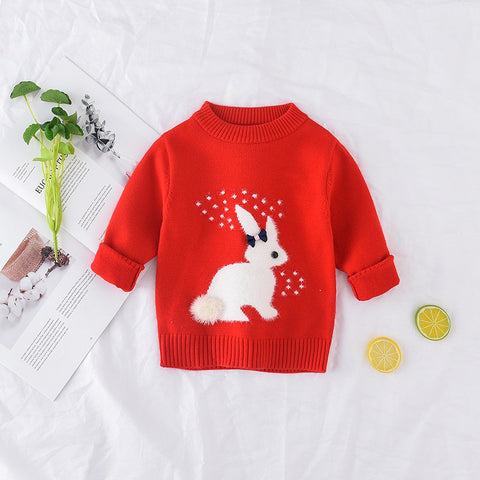 Red sweater with a white rabbit design on a light background