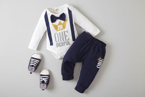 Baby outfit set with white onesie, navy pants, and shoes on a white background