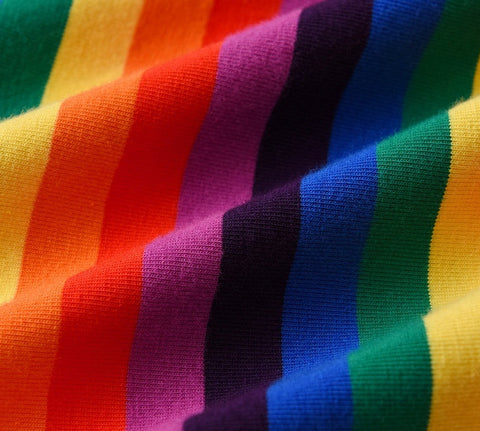 Multicolored striped fabric with rainbow pattern on a blue background