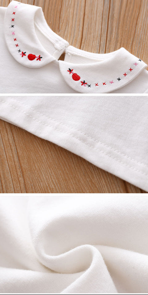 White blouse with a decorative collar on a wooden surface