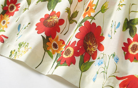 Floral fabric with red and orange flowers on a white background