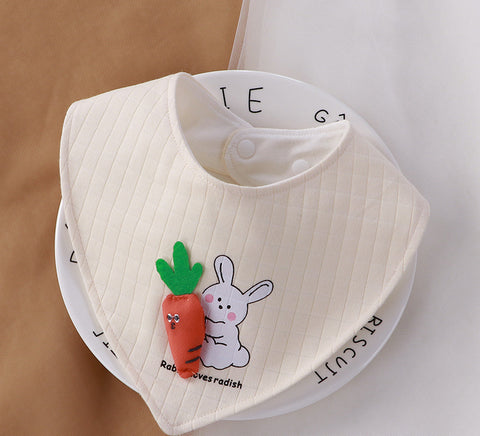 White baby bib with cartoon rabbit and carrot design on a white background