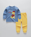Children's blue shirt with dinosaur graphic and yellow pants on a white background