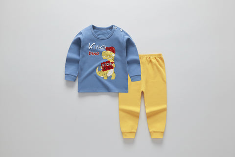 Children's blue shirt with dinosaur graphic and yellow pants on a white background