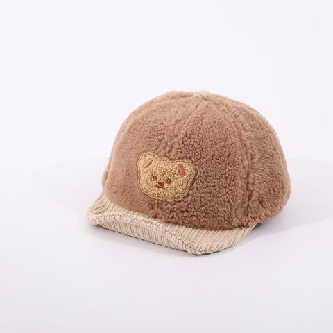 Brown fleece-lined cap with a bear patch on a white background