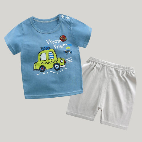 Children's blue t-shirt with a yellow car graphic and white shorts on a white background