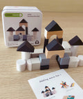 Wooden building blocks set with packaging and instructions on a wooden surface