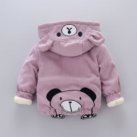 Pink hoodie with bear design on a gray surface