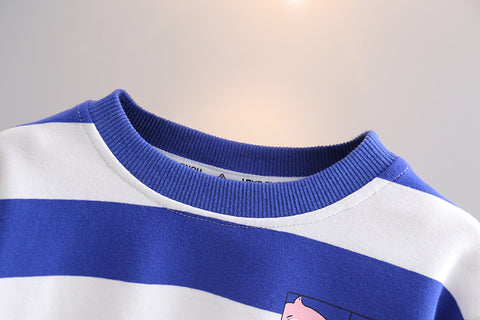Close-up of a blue and white striped sweater with a small design on a gray background