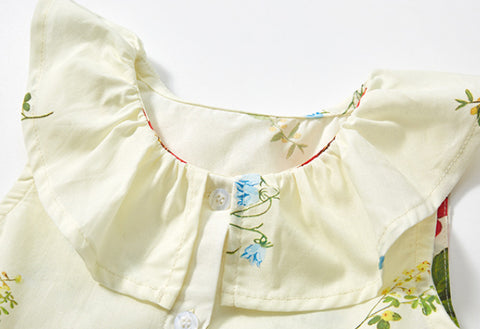 Close-up of a baby dress with floral embroidery on a white background