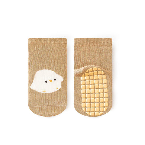 Pair of beige socks with a cartoon chick design on a white background