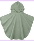 Green hooded cape on a light purple background