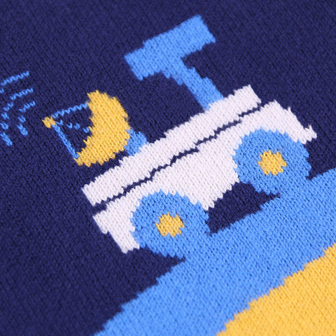 Close-up of a sock with a pixelated truck design on a dark blue background