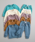 Set of children's sweatshirts and pants in various colors on a white background