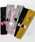 Set of colorful leggings with heart, star, and circle designs on a white background