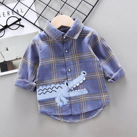 Blue plaid shirt with a crocodile design on a gray surface