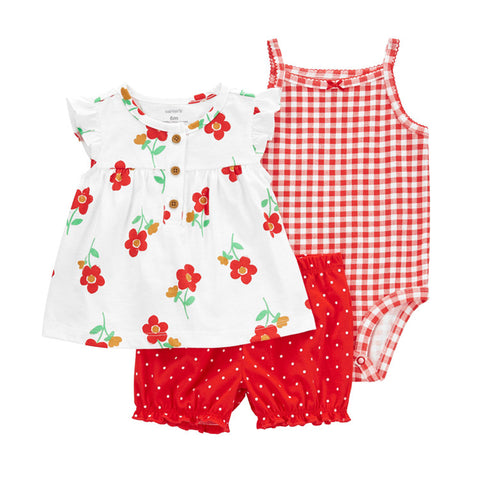 Children's outfit set with floral top, red shorts, and checkered romper on a white background